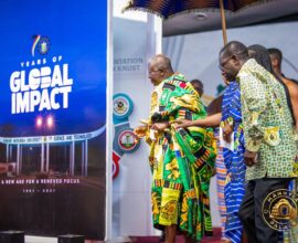 Asantehene Otumfuo Osei Tutu II unveils the commemorative anniversary book, 70 Years of Global Impact, which featured Telecel CEO, Ing. Patricia Obo-Nai.