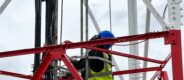 An engineer working on a cell tower to strengthen connectivity.